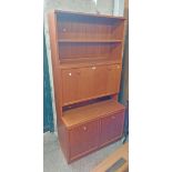 An 87cm retro G-Plan teak effect two part wall unit with two open shelves and fall-front compartment