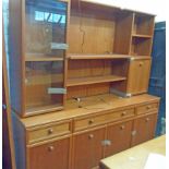 A 1.73m retro G-Plan teak effect two section wall unit with glazed top over a base with three frieze