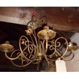 A modern wrought iron five branch ceiling candelabra with antiqued patina finish