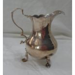 A small silver baluster form cream jug with cast scroll handle - London, 1763