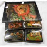 Four Russian Palekh lacquered boxes with typical colourful decoration - sold with a related