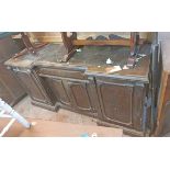 A 1.8m antique oak break front sideboard with moulded top over central blind frieze drawer and