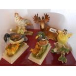 A pair of continental porcelain bird figurines, a similar pair depicting ducks and ducklings and a