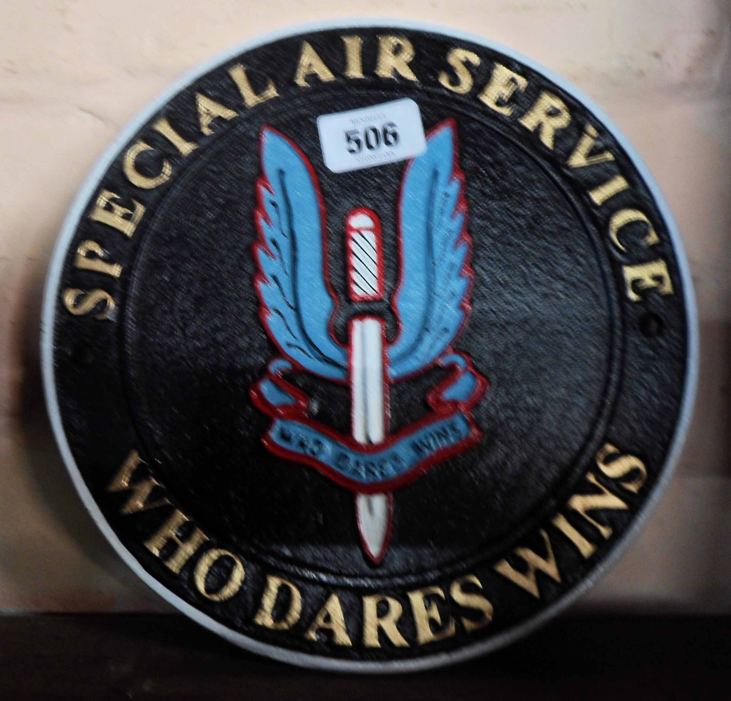 A modern painted cast iron S.A.S. Who Dares Wins sign