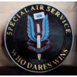 A modern painted cast iron S.A.S. Who Dares Wins sign