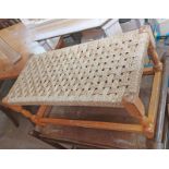 A blonde wood framed seagrass seated dressing stool