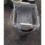 A galvanised bucket containing plant pots, wire baskets, etc.