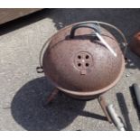 A steel outdoor barbeque of cauldron form with dome cover