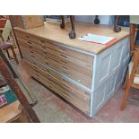 A 1.48m vintage stripped mixed wood plan chest with flight of ten drawers, set on plinth base