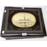 A black lacquered photograph album with titles and image to cover H.M.S. Hawkins, China Station,