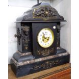 A late Victorian large ornate black slate and marble cased mantel clock with cast metal frieze and