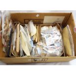 A box containing a large collection of 20th Century GB and world stamps, loose and on paper, many in