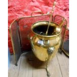 An old brass coal bucket of urn form, with cast lion mask finials and lion paw feet - sold with a
