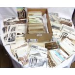 A shoe box containing a large collection of early 20th Century and later postcards including