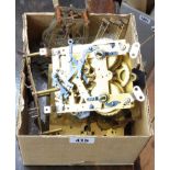 A box containing four assorted clock movements including Junghans chiming example