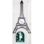 A metal model Eiffel tower wall timepiece with battery movement - sold with a reproduction Persil