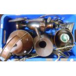 A crate containing a quantity of assorted copper and brassware, including kettles, candlesticks,