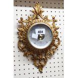 A small gilt metal SB aneroid wall barometer in the cartel style with visible works to dial centre