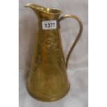 An Art Nouveau period brass jug by Joseph Sankey & Sons with embossed flower and whiplash