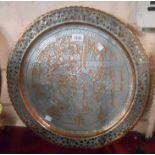 A Persian copper tray with silvered overlay depicting musicians and dancing ladies with pierced rim