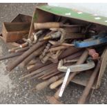 A lawn mower grass collection box containing a collection of clamps and tools