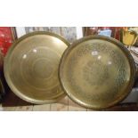 Two large old Eastern embossed and chased brass trays