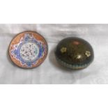 A small cloisonne lidded box of domed form decorated with flowers and scrolls on black ground - sold