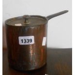 A Victorian copper saucepan and lid with cast iron handles