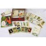 A box containing a collection of loose Brooke Bond tea cards (various part sets) an album of same