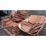 A large quantity of Rosemary red clay terracotta roof tiles including wheelbarrow