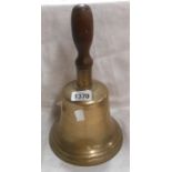 A large old cast bronze school type bell with turned wooden handle - no clapper