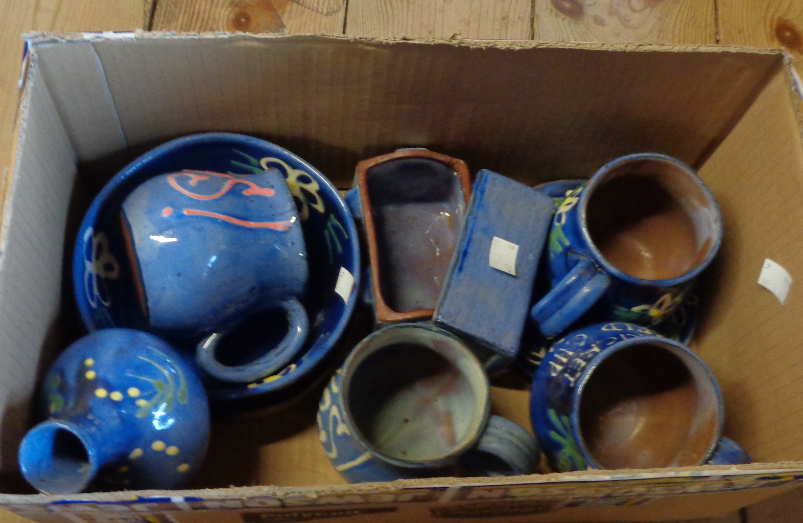 A box containing a quantity of Barbados Earthworks studio pottery comprising mugs, bowls, vase,