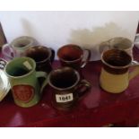 A quantity of studio pottery mugs including Jeremy Leach, etc.