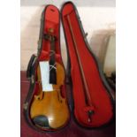 A vintage 1/2 size student's violin and bow in hard shell case