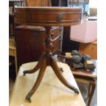 A 50cm diameter reproduction mahogany drum table with leather inset top and two drawers, set on