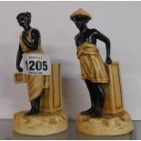 A pair of 19th Century German porcelain figural spill vases, each depicting an exotic worker, with