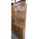 An 87cm vintage oak two part book cabinet with blind fretwork frieze and two pairs of glazed panel