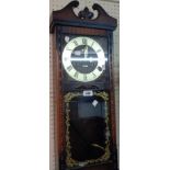 A reproduction stained wood cased Acctim wall clock with visible pendulum and thirty day striking