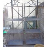 A pair of black painted metal four tier plant stands