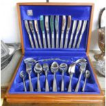 A retro oak canteen containing a six place setting of Viners stainless steel cutlery with floral