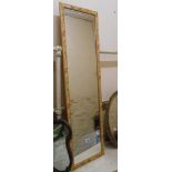 A modern narrow oblong wall mirror with decorative frame