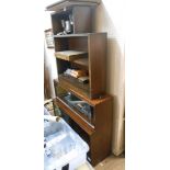 An 89cm retro polished mixed wood Minty two section modular bookcase enclosed by glass sliding doors