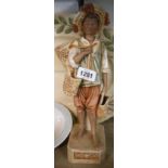 An early 20th Century Royal Dux porcelain figurine depicting a young man carrying baskets -