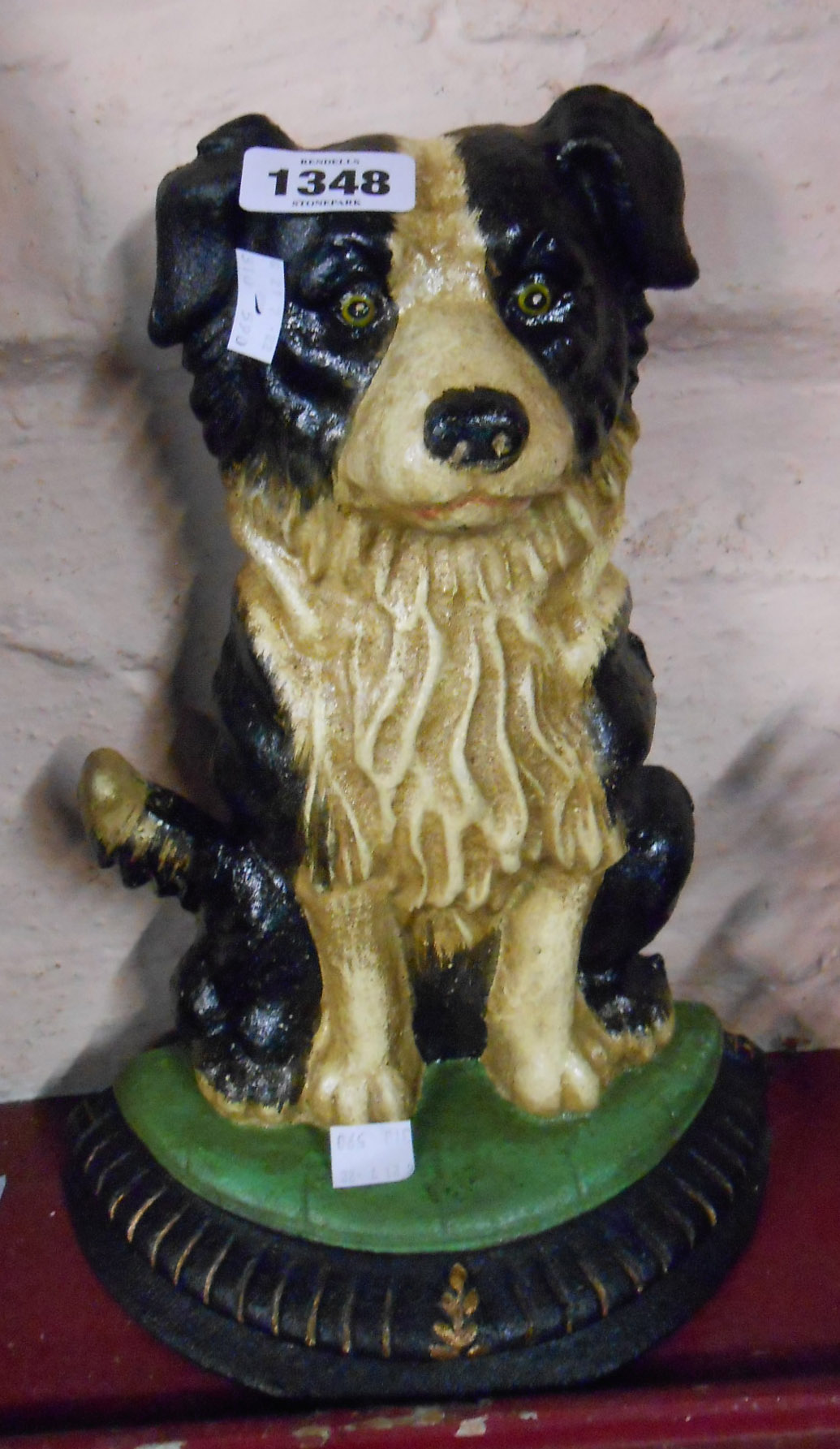 A modern painted cast iron doorstop in the form of a collie dog