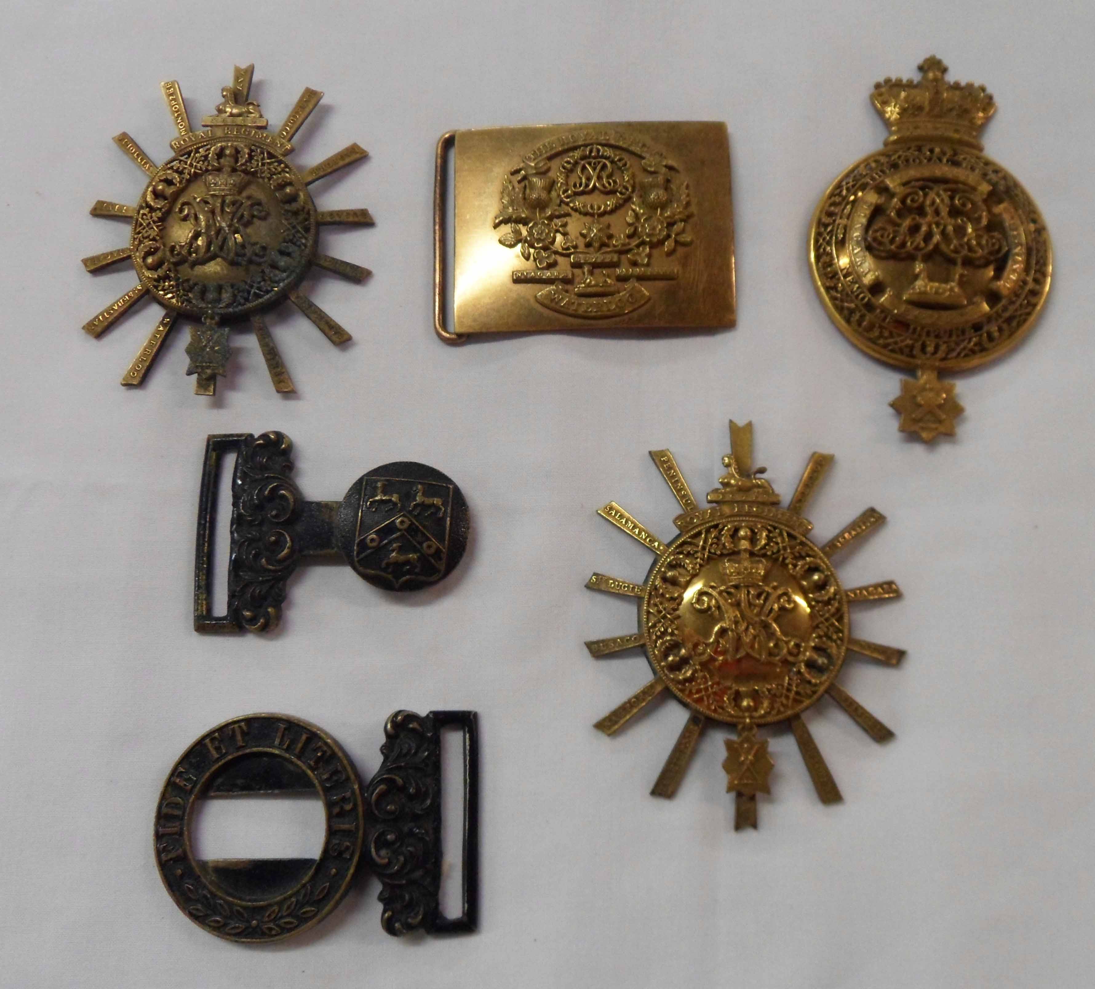 Three antique gilt metal insignia badges and a part belt buckle for The Royal Highland Regiment (