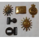 Three antique gilt metal insignia badges and a part belt buckle for The Royal Highland Regiment (