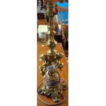 A mid 20th Century cast brass table lamp of classical stick form with cherub decoration