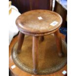 An antique stained oak stool with circular top, set on quadruple turned legs