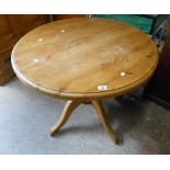 A 91cm modern pine circular pedestal dining table, set on turned pillar and quadruple legs