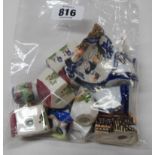 A bag containing a quantity of assorted miniature ceramic figures including cottages, figurines,